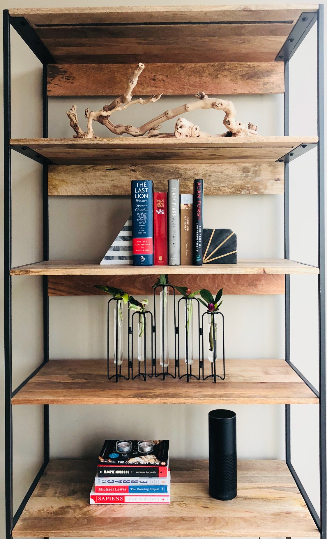 Styled bookshelf with natural wood pieces and books